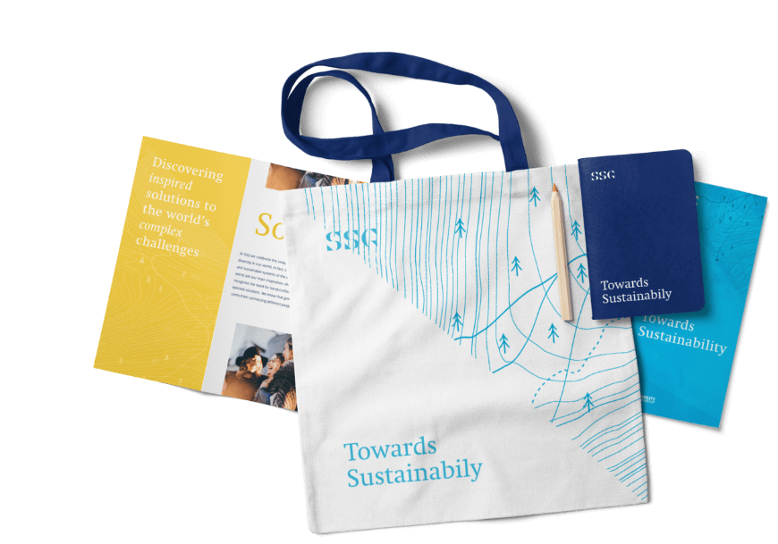 SSG brand application on a tote bag, notebook and a folding brochure